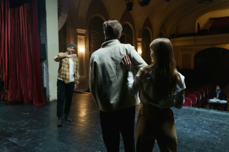 Actors in rehearsal on stage, capturing the art and emotion of theater.